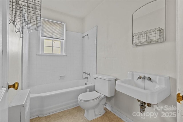343 Wakefield Dr Unit C, Charlotte, NC 28209 - bathroom with toilet, washtub / shower combination, a sink, baseboards, and tile patterned floors