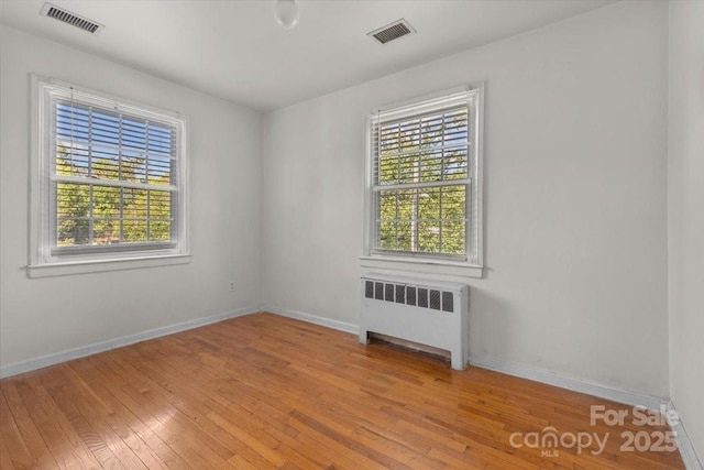 343 Wakefield Dr Unit C, Charlotte, NC 28209 - empty room with radiator, light wood-style floors, and baseboards