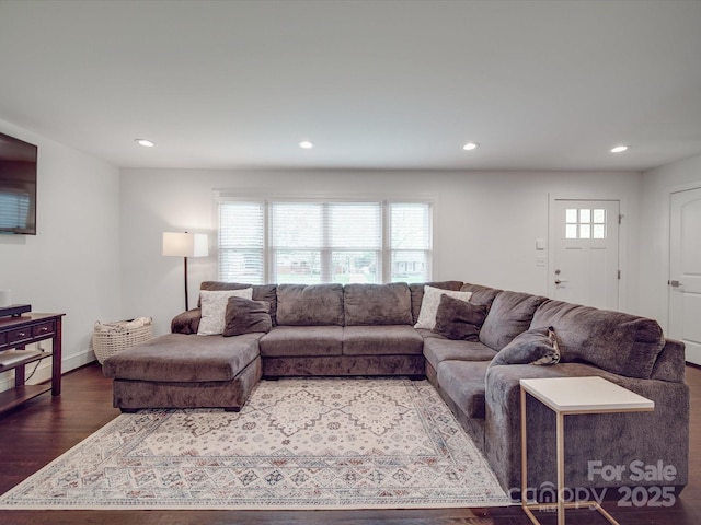 living area with baseboards, wood finished floors, and recessed lighting