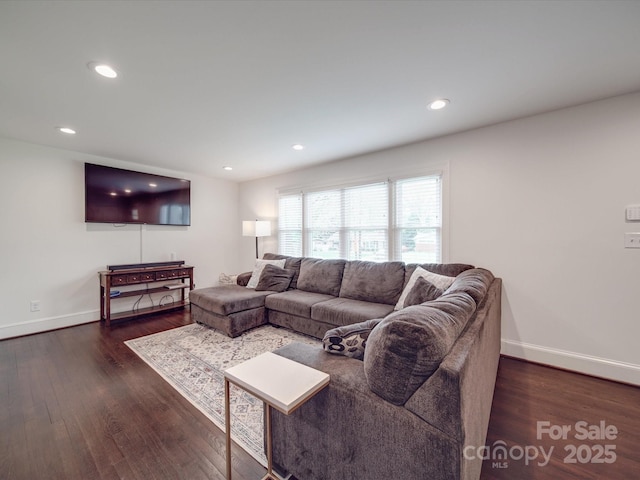 living area featuring baseboards, dark wood-style flooring, and recessed lighting