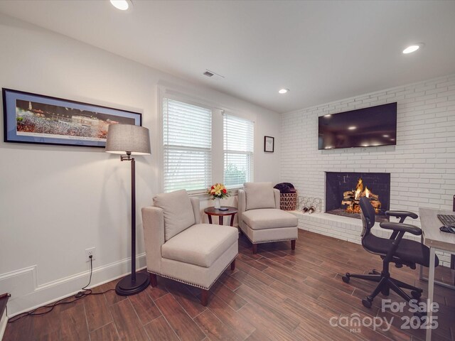 office space with recessed lighting, wood finished floors, visible vents, baseboards, and a fireplace