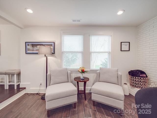 sitting room with dark wood-style floors, baseboards, visible vents, and recessed lighting