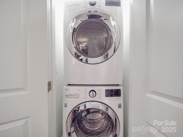 laundry room with stacked washing maching and dryer and laundry area