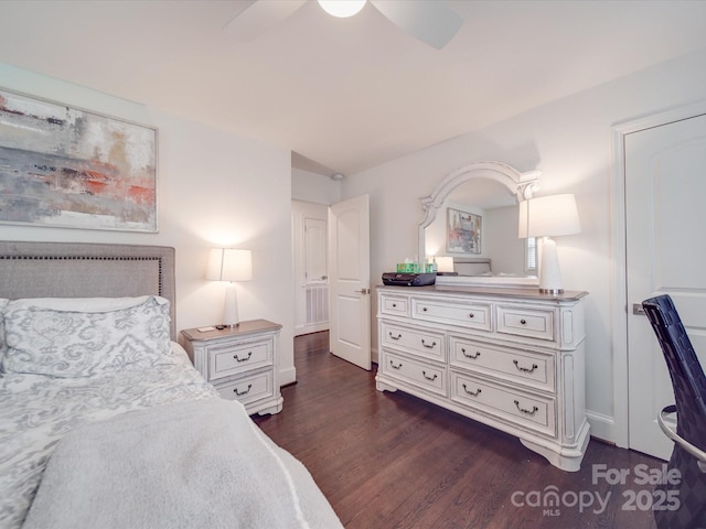 bedroom with baseboards, ceiling fan, and dark wood-style flooring