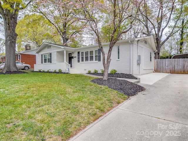single story home with brick siding, fence, driveway, and a front yard