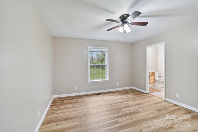 510 Laurel St, Hendersonville, NC 28792 - unfurnished bedroom featuring ensuite bath, light wood-style floors, baseboards, and ceiling fan