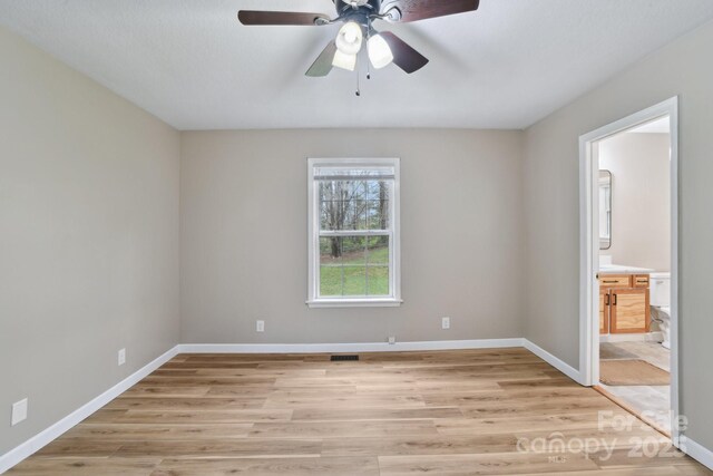 510 Laurel St, Hendersonville, NC 28792 - unfurnished bedroom featuring ensuite bathroom, baseboards, and light wood finished floors