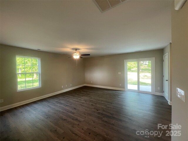 58 Simpson Rd, Pageland, SC 29728 - unfurnished room with healthy amount of natural light, dark wood-style flooring, and a ceiling fan