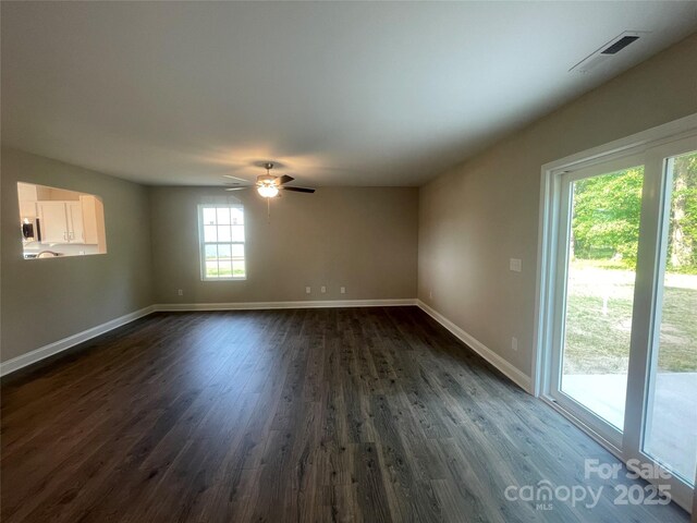 58 Simpson Rd, Pageland, SC 29728 - empty room featuring dark wood finished floors, baseboards, and a ceiling fan