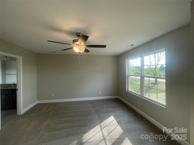 58 Simpson Rd, Pageland, SC 29728 - unfurnished room featuring a ceiling fan, baseboards, dark carpet, and a sink