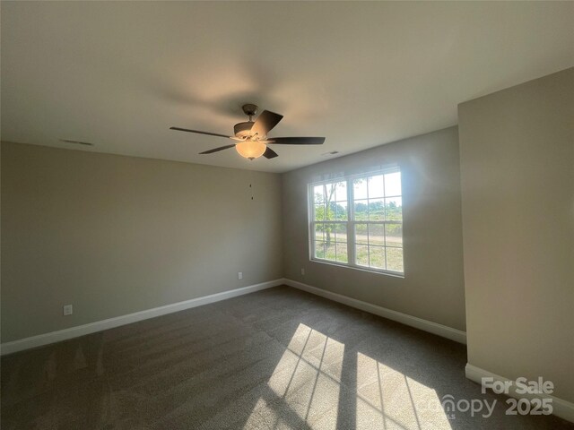 58 Simpson Rd, Pageland, SC 29728 - empty room featuring baseboards, a ceiling fan, and dark colored carpet