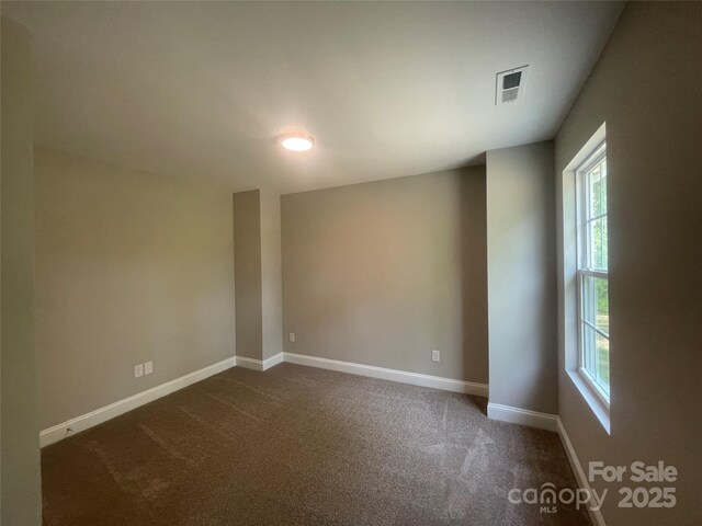 58 Simpson Rd, Pageland, SC 29728 - spare room with healthy amount of natural light, dark carpet, and baseboards