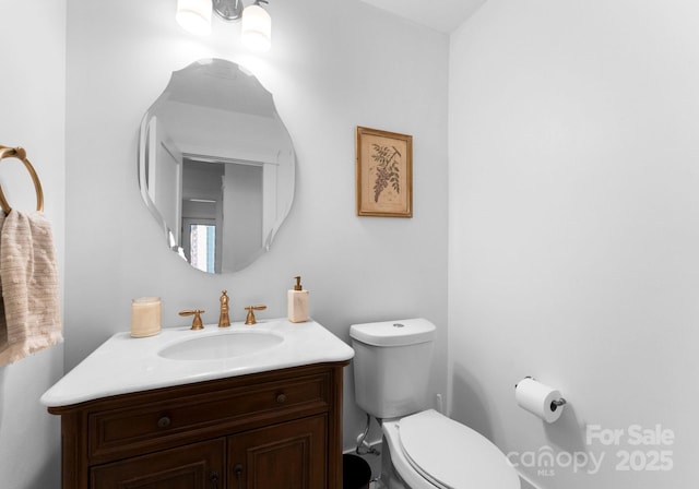 bathroom featuring toilet and vanity