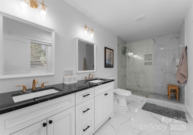 full bathroom with marble finish floor, toilet, a sink, and a marble finish shower
