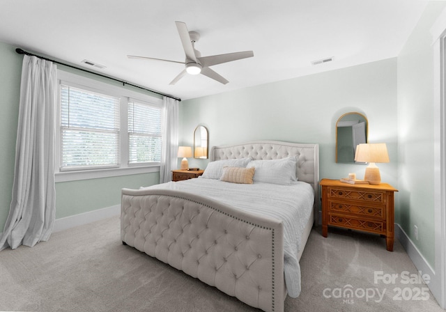 carpeted bedroom featuring baseboards, a ceiling fan, and visible vents