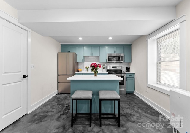 kitchen with blue cabinetry, a center island, appliances with stainless steel finishes, and finished concrete floors