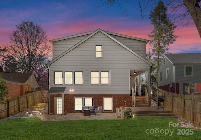 rear view of house featuring a lawn, a fenced backyard, an outdoor hangout area, and a patio