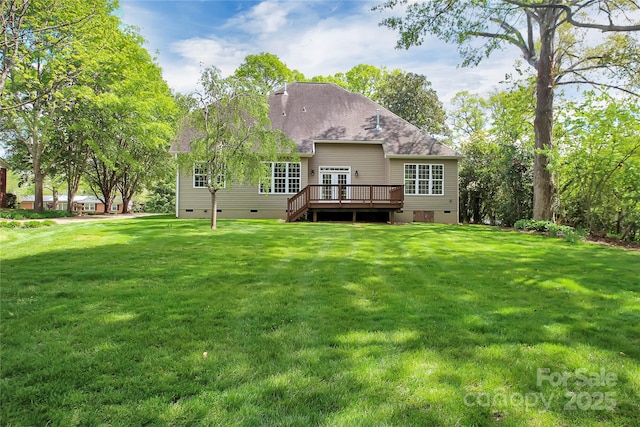 back of property with crawl space, a yard, a shingled roof, and a wooden deck
