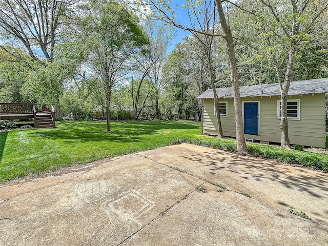 view of patio with an outbuilding and a deck