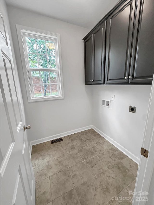 laundry area with hookup for an electric dryer, baseboards, washer hookup, and cabinet space