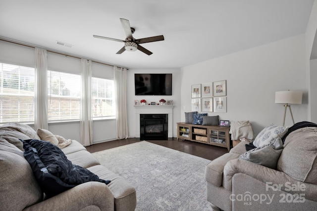 15127 Oleander Dr, Charlotte, NC 28278 - living area featuring visible vents, ceiling fan, wood finished floors, and a glass covered fireplace