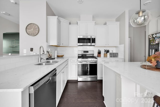 15127 Oleander Dr, Charlotte, NC 28278 - kitchen featuring appliances with stainless steel finishes, light stone counters, white cabinets, decorative backsplash, and a sink