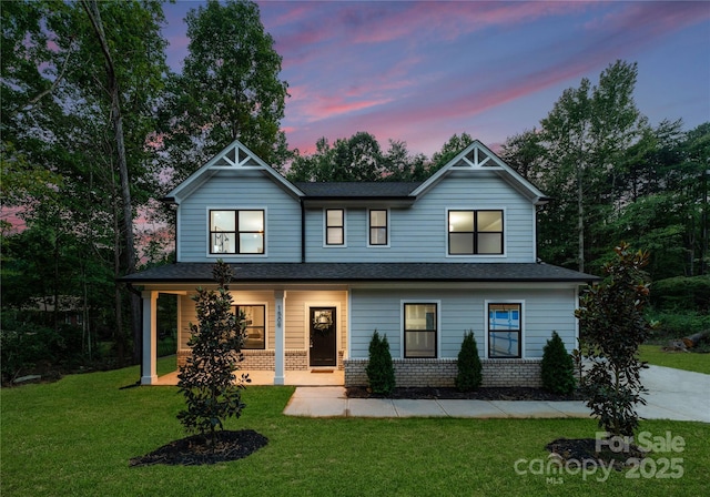 6524 Robert St, Huntersville, NC 28078 - view of front of home with brick siding, a porch, a front lawn, and a shingled roof