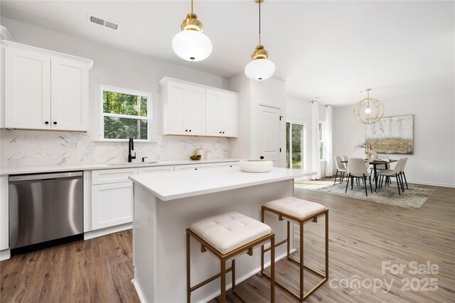 6524 Robert St, Huntersville, NC 28078 - kitchen with light countertops, dishwasher, visible vents, a sink, and decorative backsplash