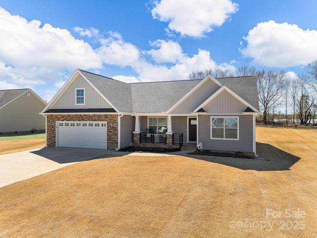 218 Little Man Dr, Boiling Springs, SC 29316 - craftsman-style house featuring concrete driveway, board and batten siding, a front yard, a porch, and a shingled roof