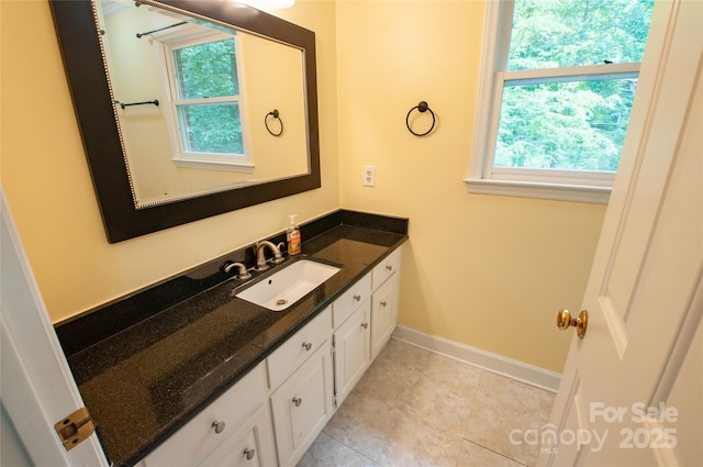 2540 Heritage Cir, Statesville, NC 28625 - bathroom with vanity, plenty of natural light, baseboards, and tile patterned floors