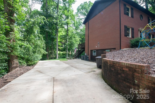 2540 Heritage Cir, Statesville, NC 28625 - view of home's exterior with stairway, brick siding, and a patio area