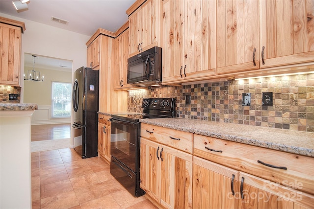 kitchen featuring visible vents, black appliances, light brown cabinets, and tasteful backsplash