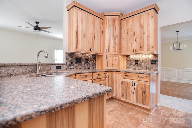 kitchen featuring backsplash, a sink, and light brown cabinets