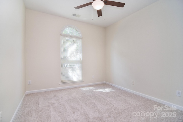 unfurnished room with visible vents, a ceiling fan, carpet, and baseboards