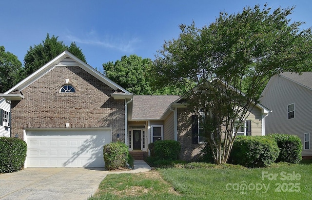 view of front of house with a garage, a front yard, driveway, and brick siding