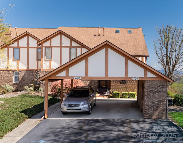 704 Fleetwood Plz, Hendersonville, NC 28739 - english style home with brick siding, roof with shingles, and driveway