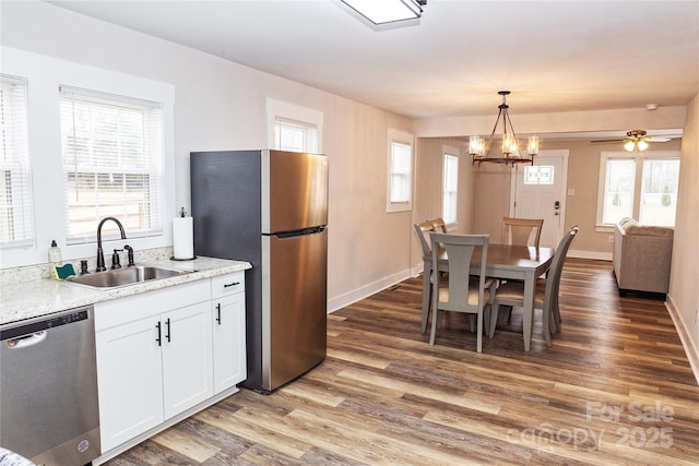 2693 Salem Church Rd, Lincolnton, NC 28092 - kitchen with wood finished floors, a sink, white cabinetry, baseboards, and appliances with stainless steel finishes