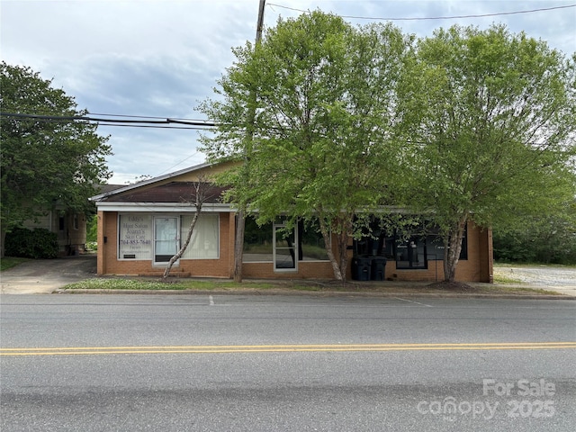 obstructed view of property featuring brick siding