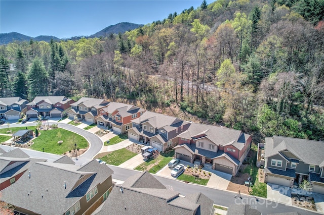 aerial view featuring a forest view, a mountain view, and a residential view