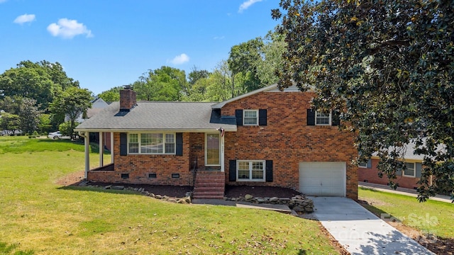 tri-level home with concrete driveway, a chimney, a front yard, a garage, and brick siding