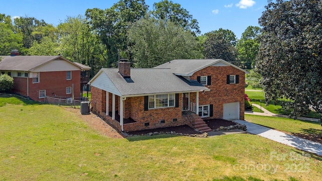 split level home with an attached garage, driveway, a chimney, and a front yard