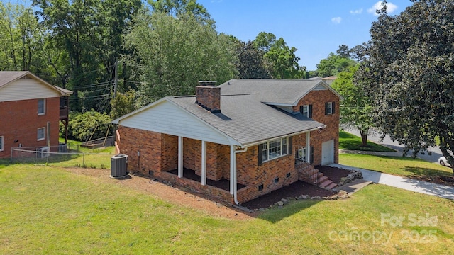 back of house featuring cooling unit, a chimney, fence, a garage, and a yard