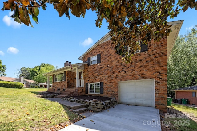 tri-level home with brick siding, an attached garage, a front yard, and concrete driveway