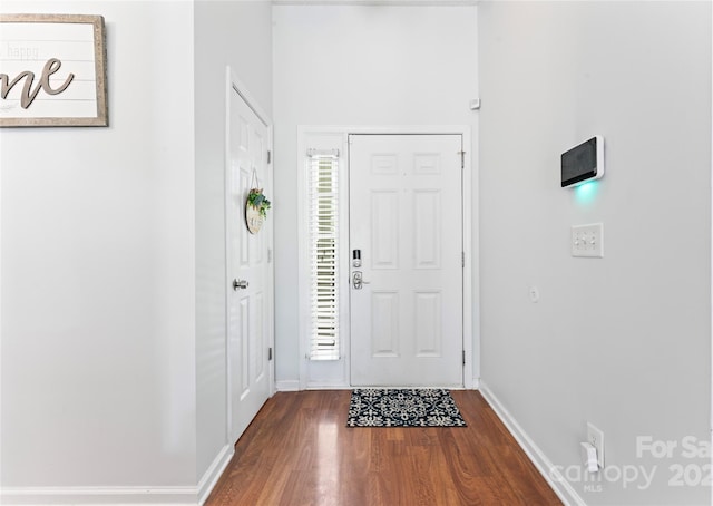 entrance foyer with baseboards and dark wood-style floors