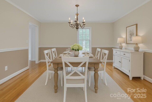 63 Frost Ln, Taylorsville, NC 28681 - dining room with a chandelier, light wood-type flooring, crown molding, and baseboards