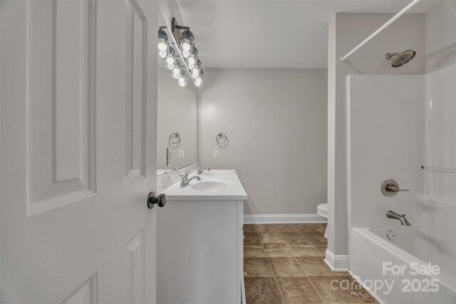 63 Frost Ln, Taylorsville, NC 28681 - bathroom with toilet, washtub / shower combination, vanity, and baseboards