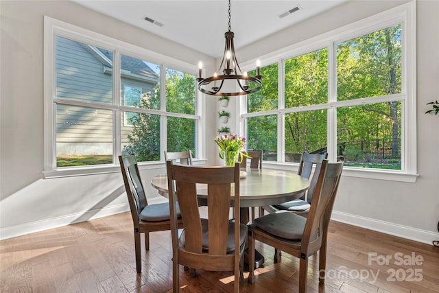 4012 Brandywine Ter, Lancaster, SC 29720 - dining space with visible vents, wood finished floors, a chandelier, and baseboards