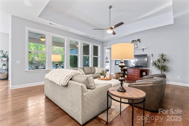 4012 Brandywine Ter, Lancaster, SC 29720 - living room with ceiling fan, a raised ceiling, visible vents, baseboards, and wood finished floors
