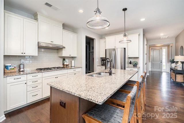 3028 Quinebaug Rd, Fort Mill, SC 29715 - kitchen featuring a sink, stainless steel appliances, a breakfast bar area, visible vents, and dark wood-style floors