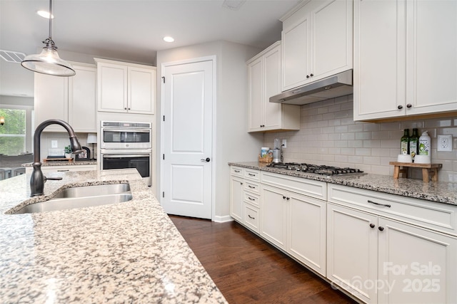 3028 Quinebaug Rd, Fort Mill, SC 29715 - kitchen featuring under cabinet range hood, dark wood-style flooring, a sink, white cabinets, and appliances with stainless steel finishes